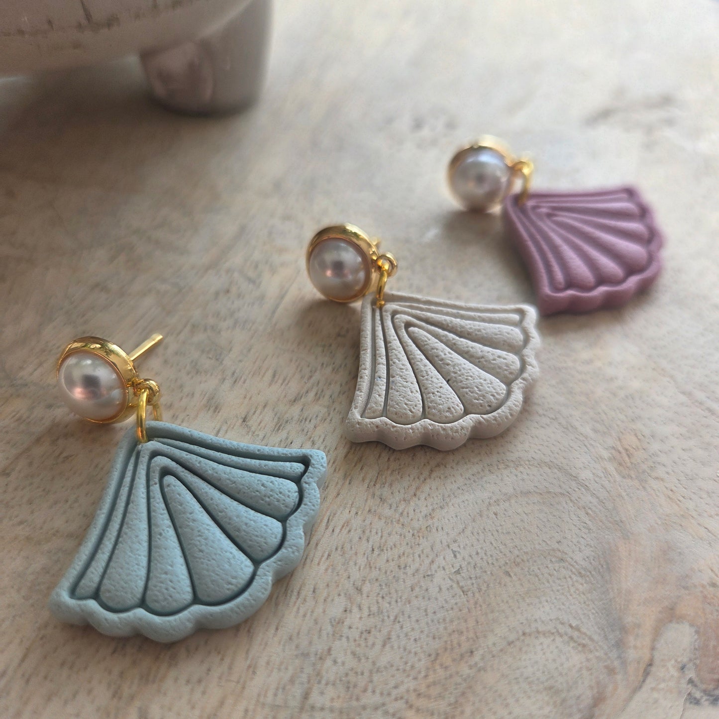 Boho Fans on a pearl stud.